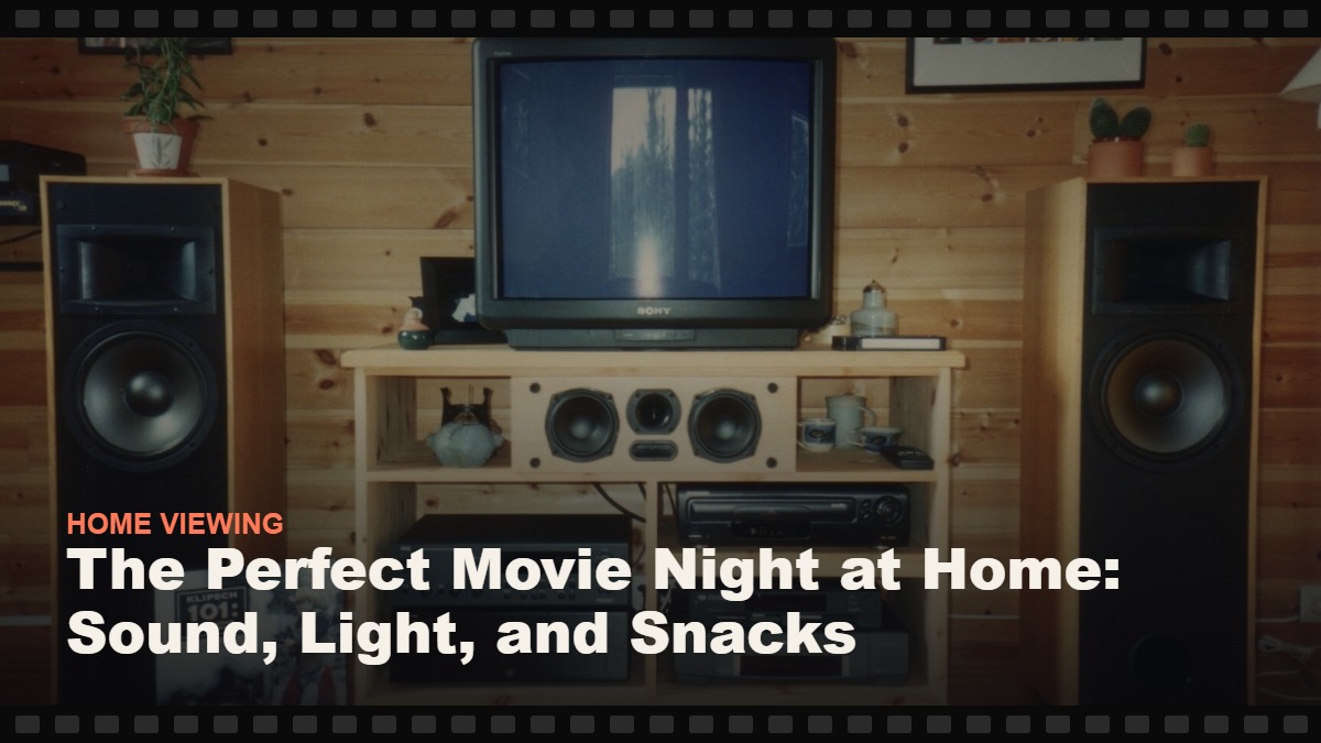 Real photograph of a home cinema setup with a television and floor-standing speakers, cover graphic for the Reelmonk guide "The Perfect Movie Night at Home: Sound, Light, and Snacks"